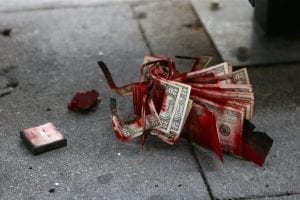 Aftermath of a Bank of America robbery. The dye pack exploded and the stack of 20s were abandoned on the sidewalk. Image by Colin Brown, CC BY 2.0, via Wikimedia Commons, no changes.