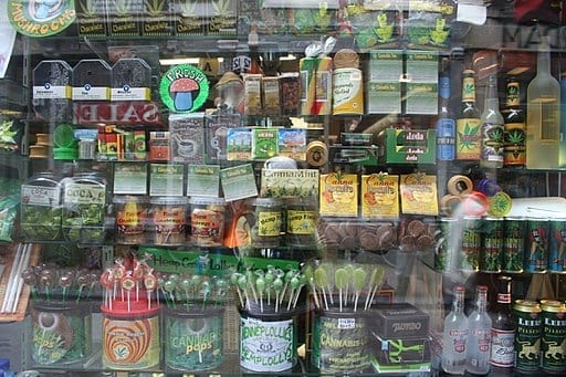 Amsterdam store window displaying various medical cannabis, hemp food and other types of products; image by nickolette, CC BY 2.0, via Wikimedia Commons, no changes.
