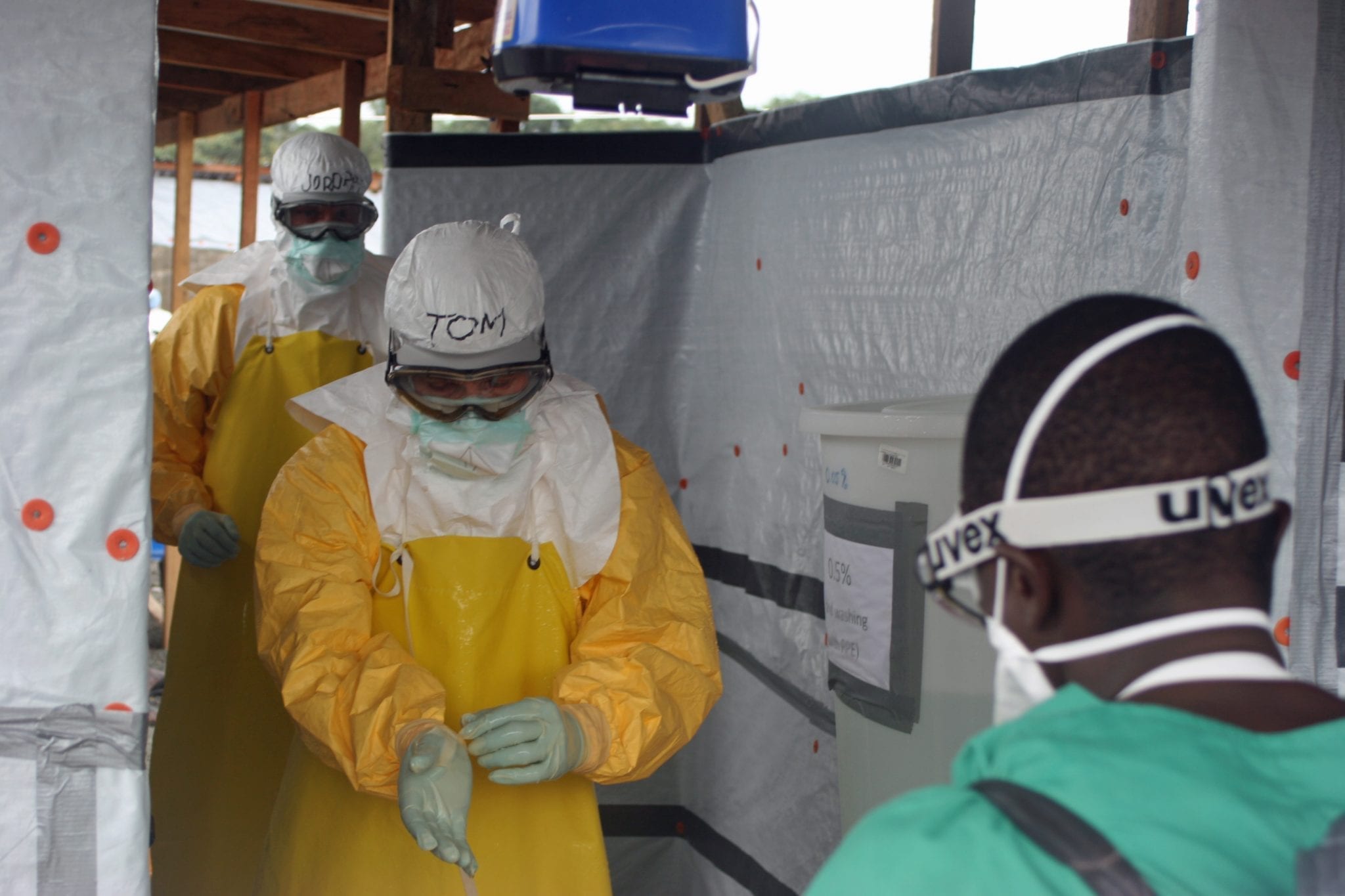 CDC Director exits Ebola treatment unit; image by CDC Global, CC BY 2.0, via Wikimedia Commons, no changes.