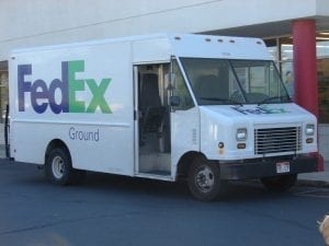 A FedEx Ground delivery van in Provo, Utah, July 2015; image by An Errant Knight (Own work), CC BY-SA 4.0, via Wikimedia Commons, no changes.