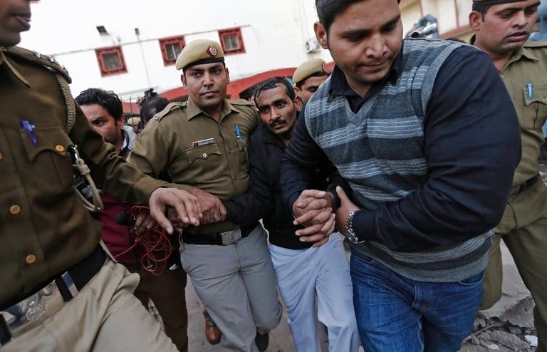 Shiv Kumar Yadav escorted by Delhi Police officers.
