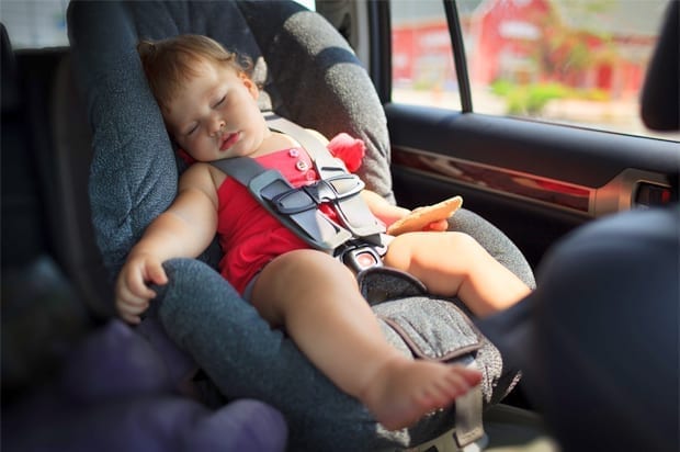 Baby sleeping in the backseat of a car; image courtesy of www.salon.com.