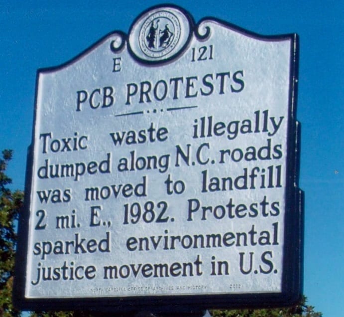 A Historic Landmark sign describes North Carolina PCB protests as the birthplace of the environmental justice movement.