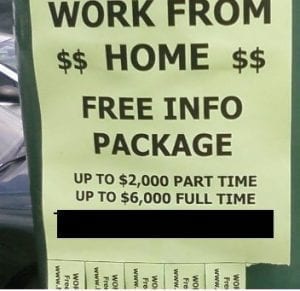 A "work from home" sign hanging in public.