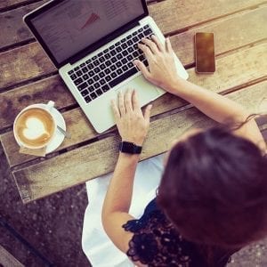 Woman working at home; image courtesy of www.paychex.com.