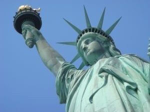 The Statue of Liberty against a blue sky.