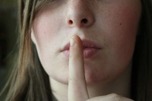 Woman holding finger to lips to show silence; image by philm1310, via Pixabay.com CC0.