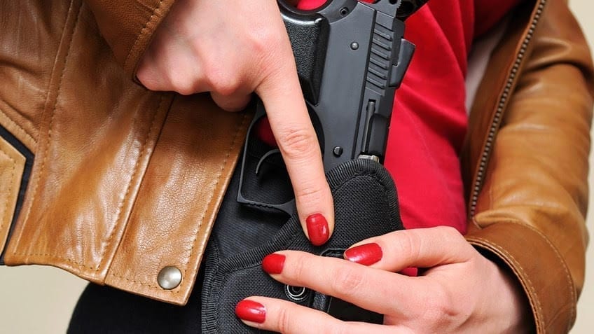 Woman with holstered gun; image courtesy of www.gunowners.org.