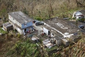 Seen from the air, the word HELP is painted on a ruined roof in Puerto Rico.