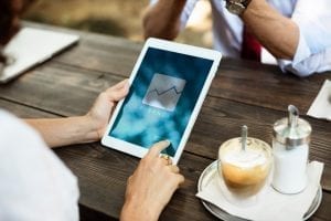 Woman using tablet to read about finance; photo by rawpixel.com on Unsplash.