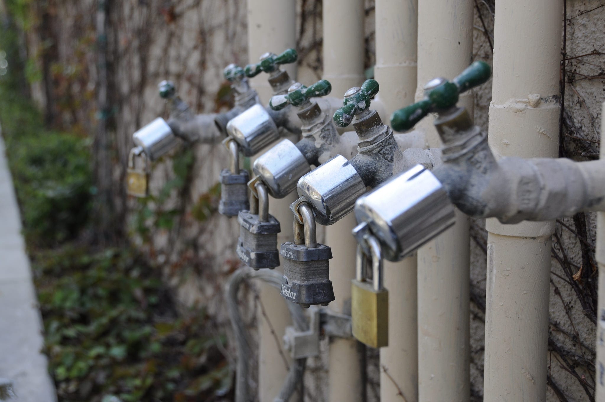 Water shortage, padlocked faucets; image courtesy Andrew Hart via Flickr.com, CC BY-SA 2.0, no changes.