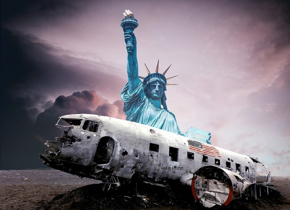 The ruined remains of a crashed airplane lay broken in front of the Statue of Liberty, backed by an ominously cloudy sky.