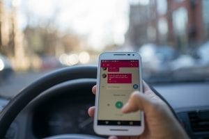 Texting while driving; image by Roman Pohorecki, via Pexels.com, CC0.