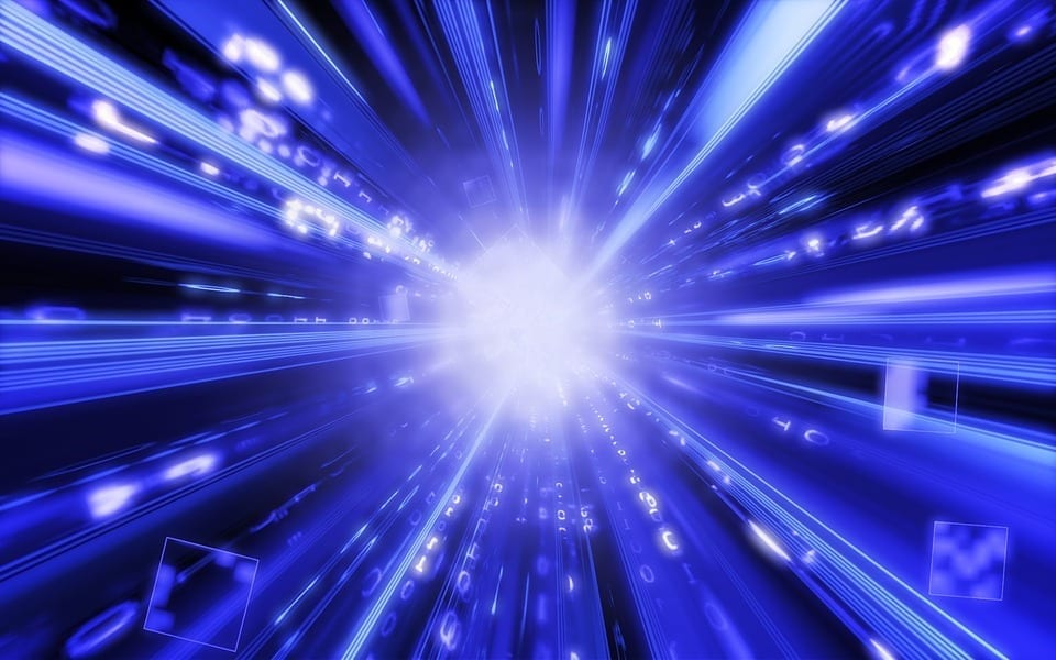 A shining burst of white light at center, surrounded by rays of blue and white light radiating outwards from the center, backed by a dark void.