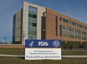 FDA Building 21 stands behind the sign at the campus's main entrance and houses the Center for Drug Evaluation and Research; image by FDA, Public domain.