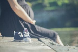 Image of a Pregnant Woman and Baby Shoes