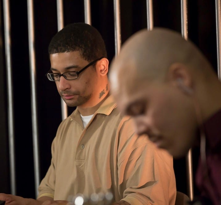 Prisoners; image from TEDxSingSing by Hudson Link, via Flickr, CC BY-SA 2.0, cropped at left.