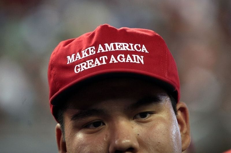 A man wearing a red hat that says "Make America Great Again."