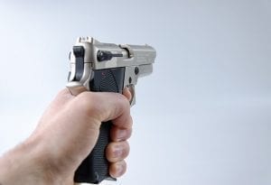Image of a person holding a gun