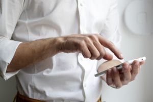 Man using smartphone. Photo by NordWood Themes on Unsplash.