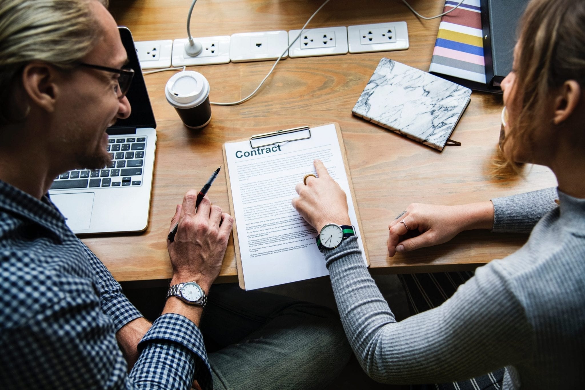 Older man and younger woman reviewing contract; image by rawpixels.com, via Pexels.