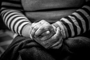 Elderly person folding their hands