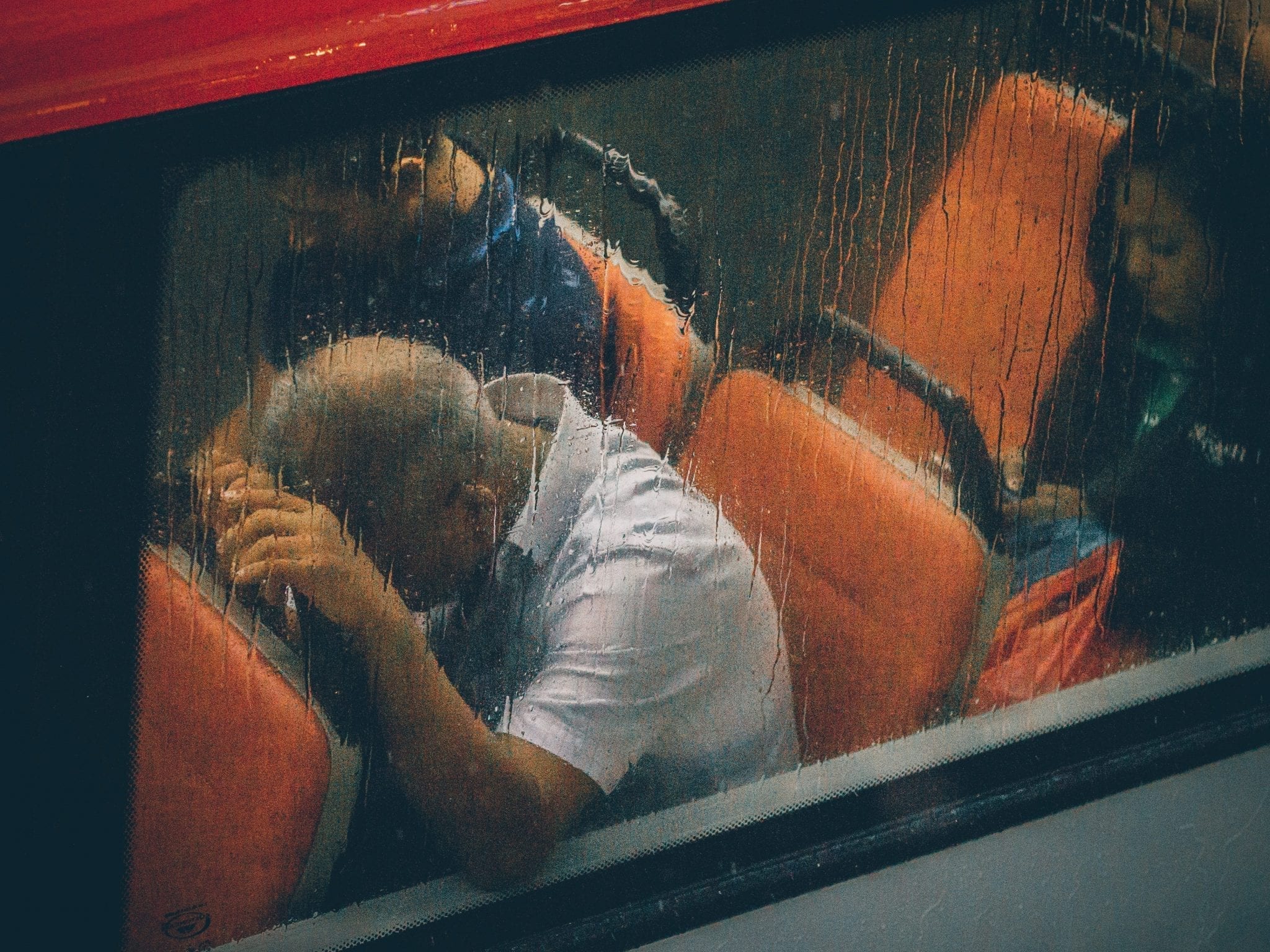 Man sleeping on train; image by Lily Banse, via Unsplash.com.