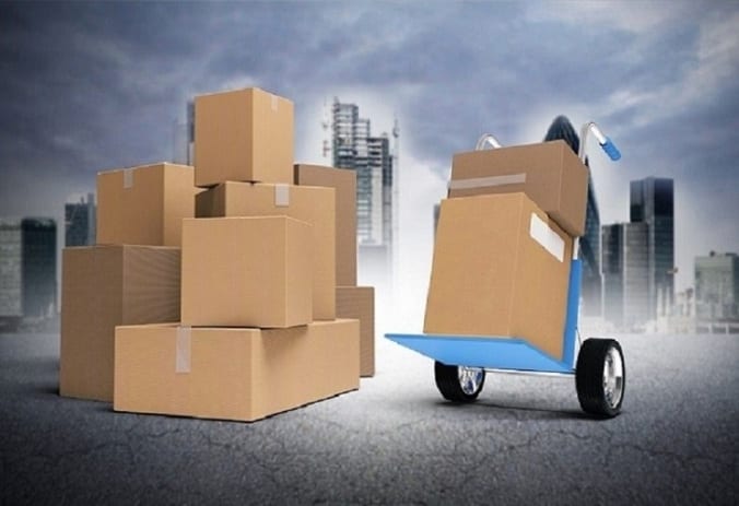 Various sizes of cardboard boxes, some on a dolly; image via Shutterstock, purchased by the author.