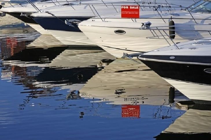 Boat with a for sale sign; image from Shutterstock, purchased by author.
