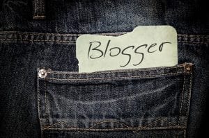 Upclose shot of blue jeans with a note saying “Blogger” in the pocket; image by kalhh, via Pixabay.com, CC0.