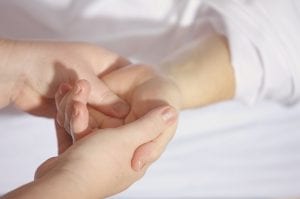 Person performing a checkup of another person's hand