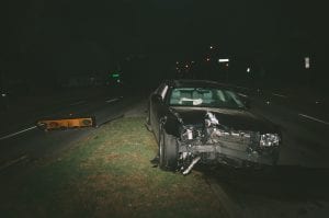 Car accident at night showing a badly damaged car; image by Matthew T. Rader, via Unsplash.com.