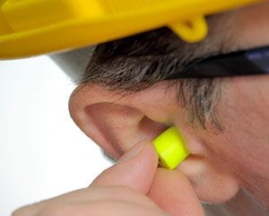 Man Inserting Earplugs