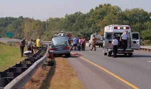 Car accident at side of road with emergency workers and ambulance; image by Ragesoss, via Wikimedia Commons, CC BY-SA 3.0, no changes.