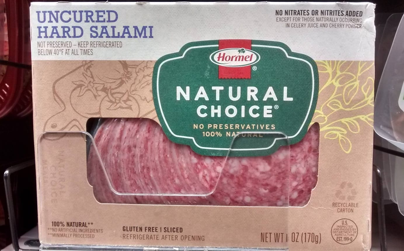 A package of Hormel's Natural Choice salami in a grocer's case.