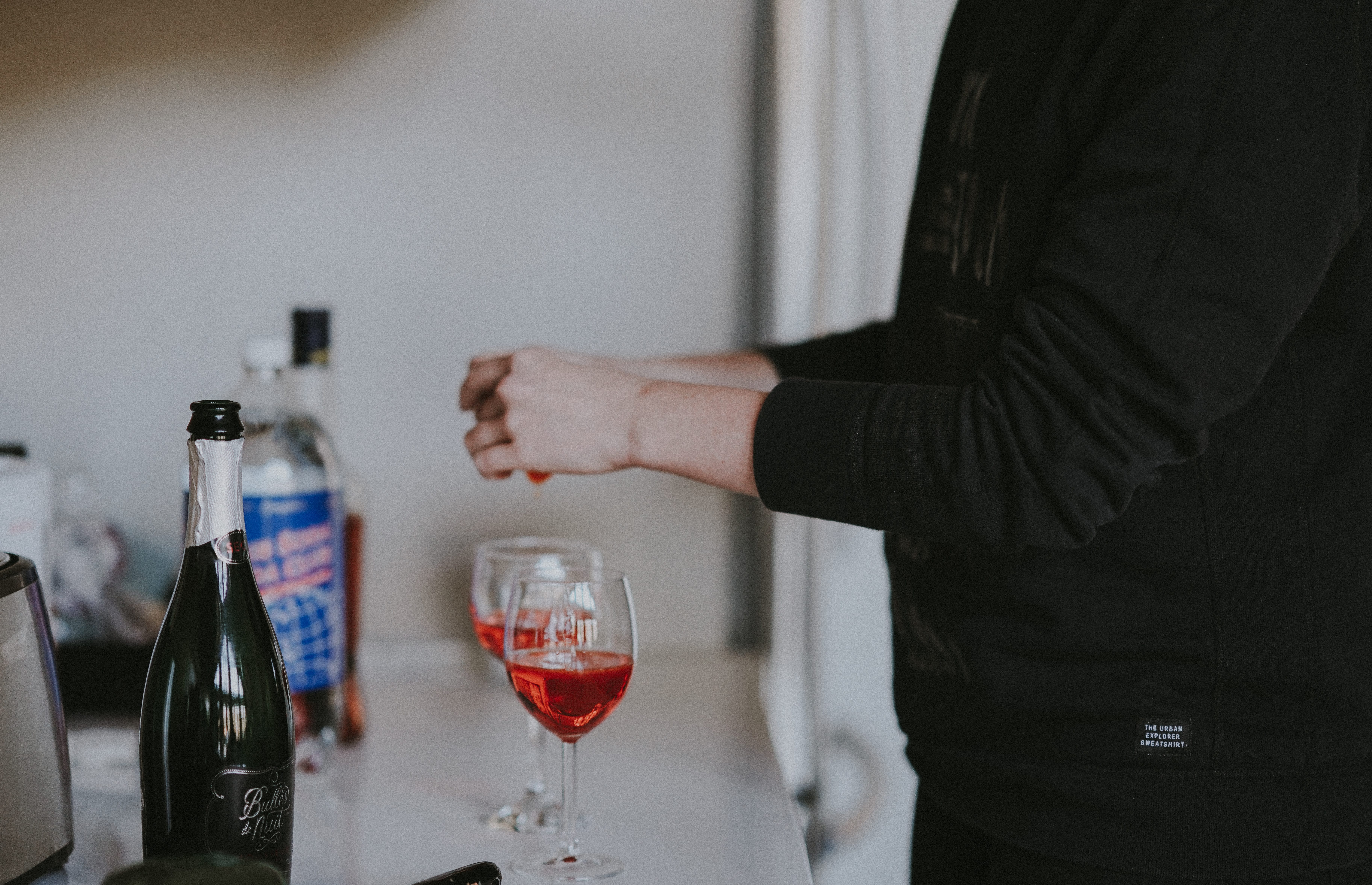 Woman making a cocktail; image by Annie Spratt, via Unsplash.com.