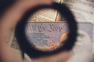 Soft focus of a magnified line from the U.S. Constitution - “We the People.” Image by Anthony Garand, via unsplash.com