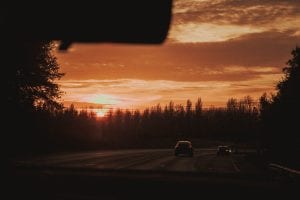 Cars driving in sunset; image by Mat Reding, via unsplash.com.