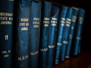 Michigan State Law Journals on bookshelf; image by Rob Girkin, via unsplash.com.