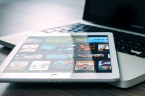 Tablet computer on top of a laptop; image by William Iven, via unsplash.com.