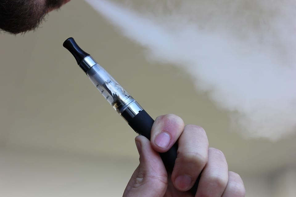 Person holding an e-cigarette