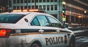 Side view of parked police car; image by Matt Popovich, via Unsplash.com.