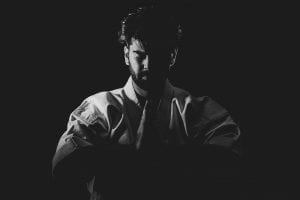 Greyscale photo of male martial artist; image by Sam Moghadam, via Unsplash.com.