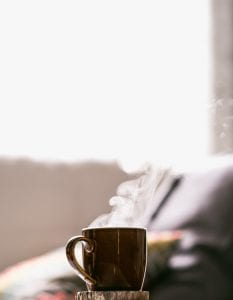 Shallow focus shot of hot coffee in mug; image by Tim Foster, via Unsplash.com.