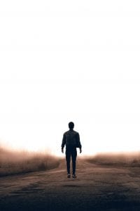 Man walking along dirt road; image by Warren Wong, via Unsplash.com.