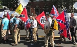 Alt-right members attending the Charlottesville 'Unite the Right' Rally in 2017, holding Nazi, Confederate, and Gadsden "Don't Tread on Me" flags.