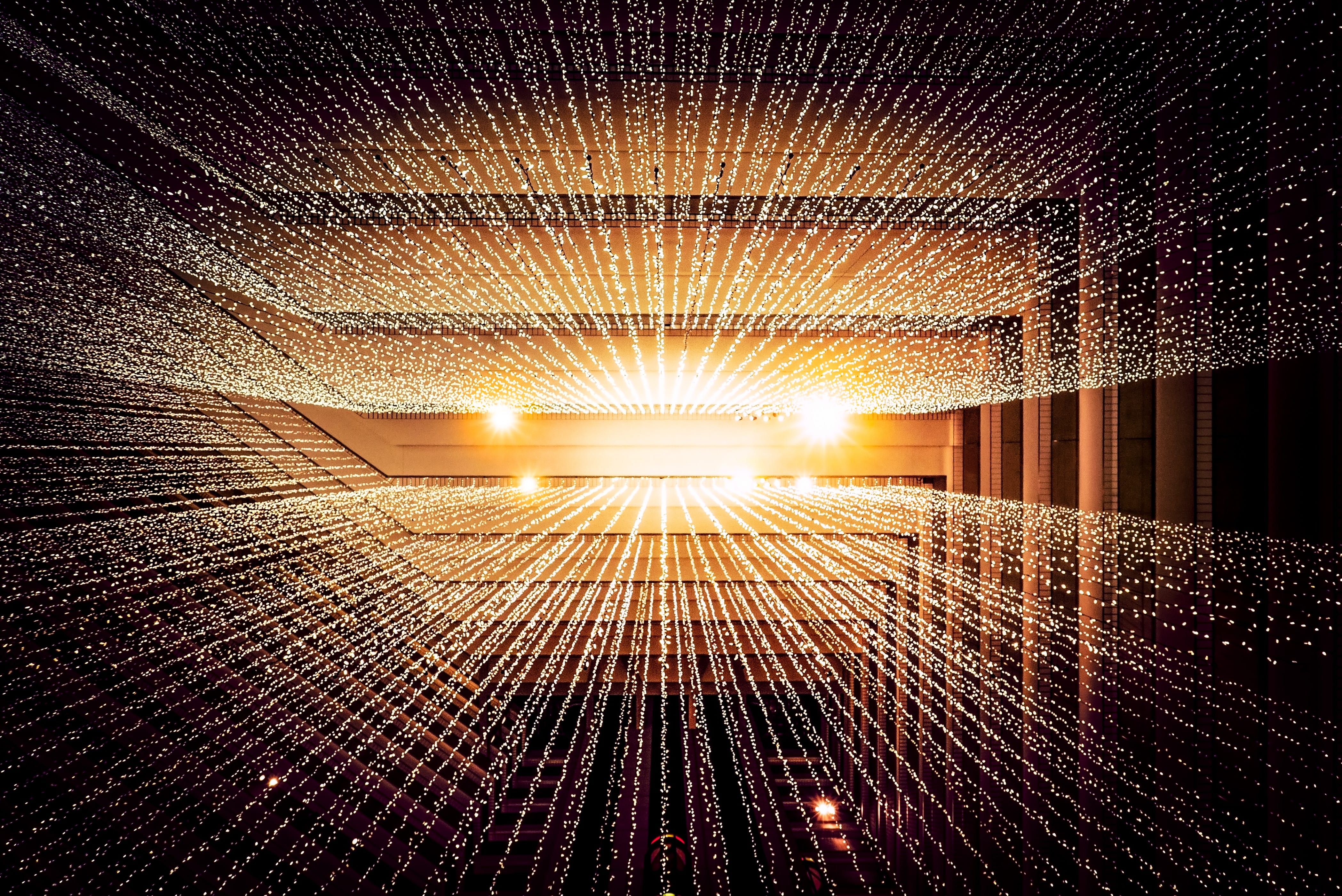 Graphic depiction of data flowing as golden light; image by Joshua Sortino, via Unsplash.com.