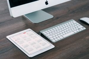 iPad and Mac on desk; image by William Iven, via Unsplash.com.