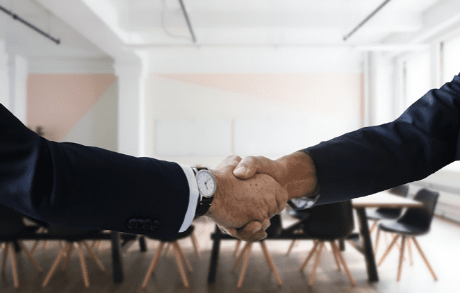 Two men shaking hands; image via Pixabay.com.