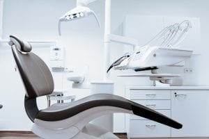 Dentist’s chair in exam room; image by Daniel Frank, via Unsplash.com.
